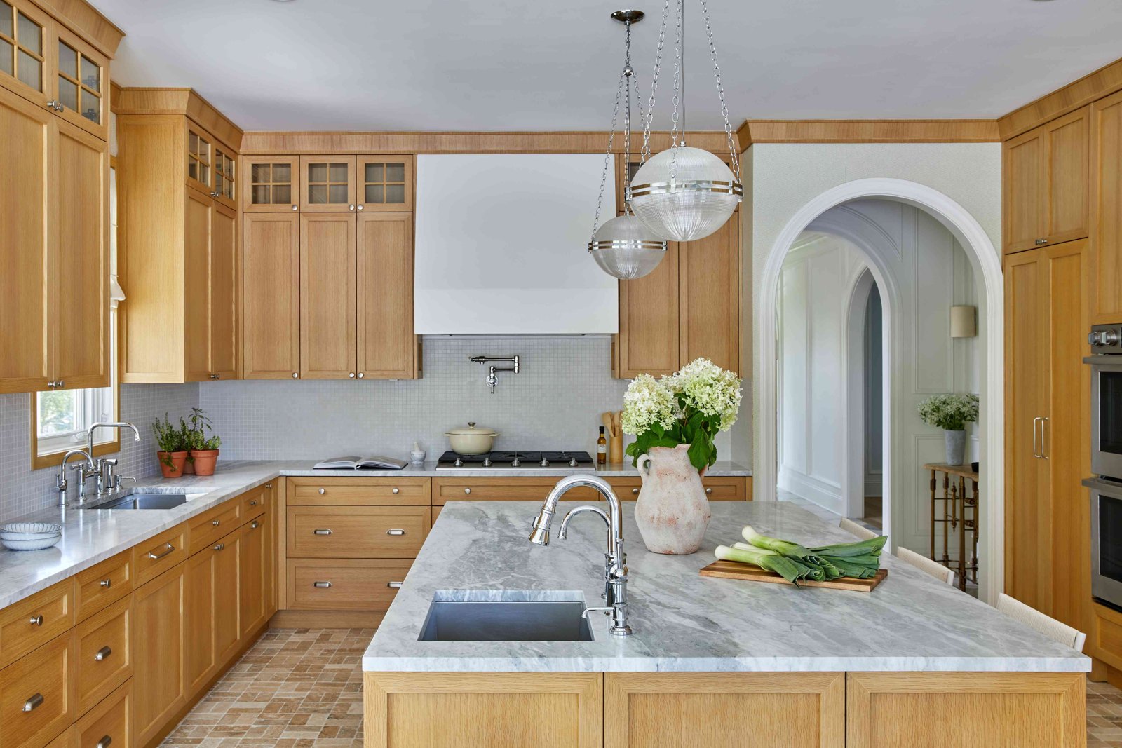Warm oak kitchen with marble island